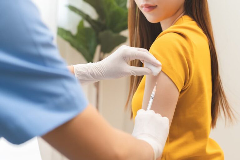 A patient receiving an HPV vaccination in the arm to prevent HPV and cancer, illustrating professional medical immunization services.